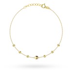 Gold bracelet with a central smooth ball and diamond-cut balls