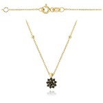 Gold necklace with a flower with black stones and smooth beads